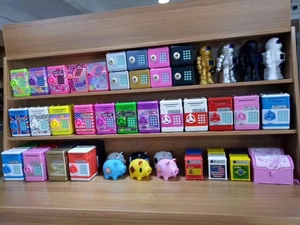 Various creative electronic ATM piggy banks and password safes on display shelves
