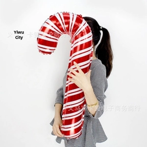 Close-up of a large red and white striped candy cane foil balloon for Christmas party decor