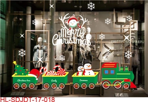 Close-up of Christmas window stickers featuring a cartoon snowman and colorful toy train