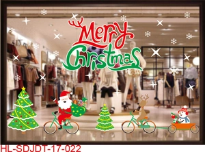 Detail of Merry Christmas window stickers featuring Santa Claus and reindeer on a shop glass