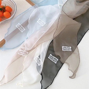 Close-up of lightweight chiffon scarves with ONEBAGEL embroidery patch in various colors