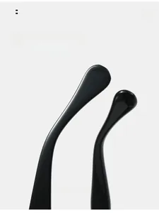 Detail view of smooth integrated nose pads on black oval sunglasses for comfort