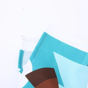 Detail of blue Christmas tablecloth fabric showing neat stitching and festive pattern
