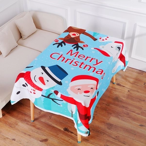 Detail of light blue Christmas tablecloth with Santa, snowman and Merry Christmas print