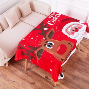Detailed top view of red Christmas tablecloth featuring Santa Claus and elk patterns