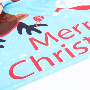 Close-up of sky blue Christmas tablecloth with Merry Christmas text and elk print