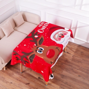 Detailed festive scene of a red Christmas tablecloth with Santa and reindeer patterns