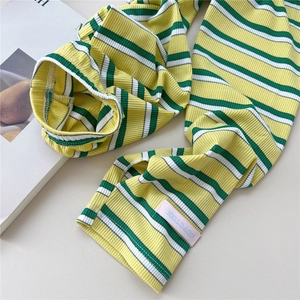 Detail showing high-elastic striped cooling arm sleeves with pink logo tag on soft knit fabric