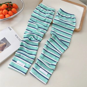 Close-up of striped sun protection arm sleeves with knitted texture and pink label