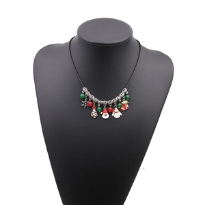 Christmas necklace with Santa, Snowman, and Tree pendants on a mannequin stand