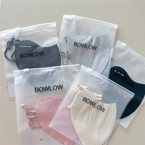 Detail of five multi-colored breathable sun protection face masks in individual zip bags