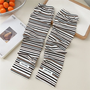 Detail of striped knitted cooling arm sleeves with ribbed texture and woven brand label