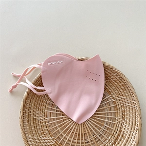 Detail of pink breathable sun mask with adjustable ear loops and ventilation holes