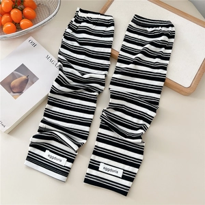 Detail of black and white striped sun protection arm sleeves with eggdoris woven label