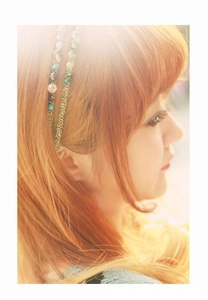 Detail of a double-layered crystal headband with colorful faceted beads on a gold frame