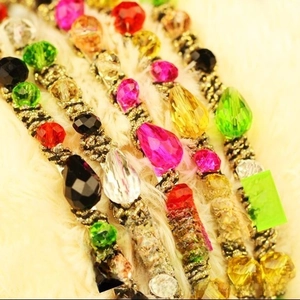 Detail of colorful faceted crystal headbands in black, white, rose, champagne, and green