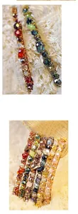 Macro detail of multicolored crystal beads on a golden wire handmade hair accessory