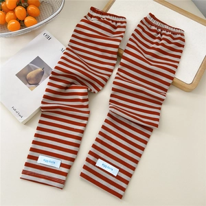 Close-up of striped cooling arm sleeves with orange and grey bands and a logo label