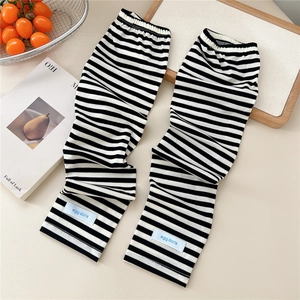 Close-up of black and white striped sun protection sleeves with a blue woven label logo