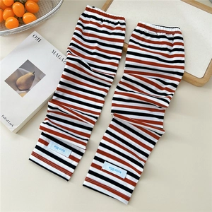 Detail of striped cooling arm sleeves featuring orange and black knit texture and elastic band