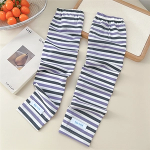 Detail of striped knitted sun protection sleeves with purple and grey bands and cuff logo