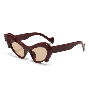 Deconstructive heart-shaped sunglasses in dark reddish brown with wavy carved edges
