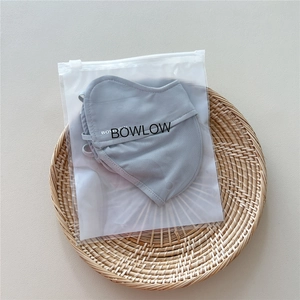 Detail view of light grey sun protection mask with breathable mesh on a woven tray