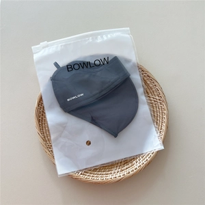 Detail of dark gray breathable sun mask with branded matte zipper packaging bag