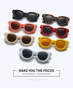 Flat lay of cat-eye sunglasses in seven assorted colors with stylish metal arrow accents