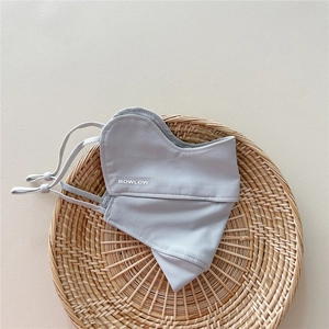 Close-up of light grey sun protection mask with breathable mesh and adjustable ear straps