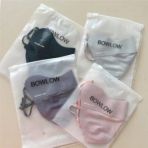 Detail of four breathable sun masks in varied colors with branded matte packaging