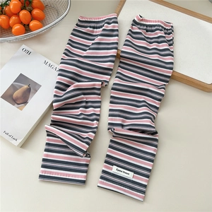 Close-up of pink and navy striped knit arm sleeves with ribbing and letter patch