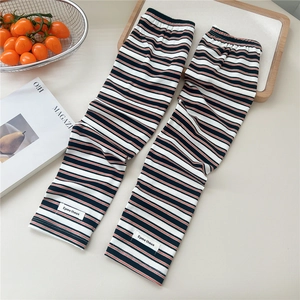Close-up of striped arm sleeves with breathable knit texture and brand label