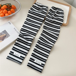 Detail of black and white striped sun protection arm sleeves with knit texture