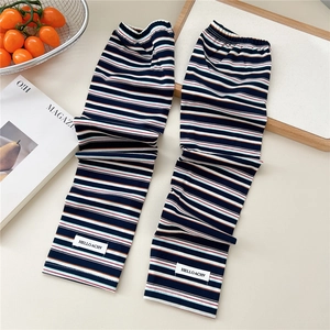 Detail of colorful striped sun protection sleeves with woven brand label on wood