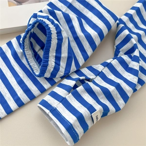 Detailed close-up of blue and white striped cooling arm sleeves with thumb hole and tag