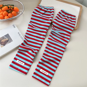 Detail of red and blue striped sun protection cooling sleeves with elastic cuffs
