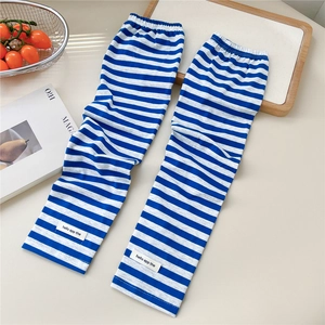 Detail of blue and white striped cooling arm sleeves with a small rectangular fabric label