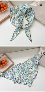 Close-up of lightweight floral scarf with elegant wave stitched edges and nice moment tag