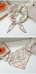 Close-up of lightweight floral silk scarf with scalloped edges and nice moment label