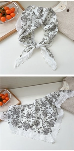 Detail of white paisley neckerchief featuring delicate lace edges and nice moment label