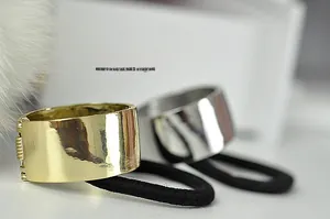 Detail of metallic gold and silver wide-band hair ties with elastic rope and hinge mechanism