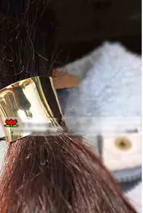 Detailed view of a minimalist cylindrical gold metal hair tie cuff for ponytails