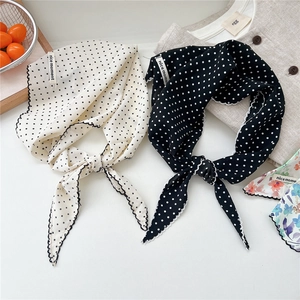 Lightweight polka dot triangle scarf with wavy edges and decorative woven label