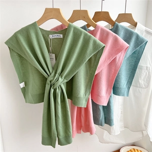 Solid color wool knitted shawl with front knot design in pastel green, pink and blue