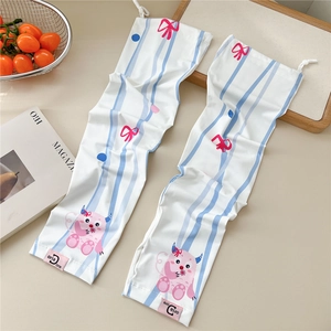Detail of white cooling arm sleeves with cute cartoon patterns and pink brand label