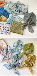 Detailed close-up showing various printed floral patterns and textures of cotton-linen scarves