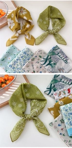 Detail of assorted cotton linen floral scarves showing intricate daisy and paisley patterns