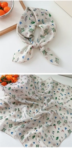 Close-up of floral cotton linen scarf with red and purple flowers and fine stitched edges