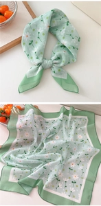 Detailed view of lightweight light green floral cotton linen square scarf with daisy prints